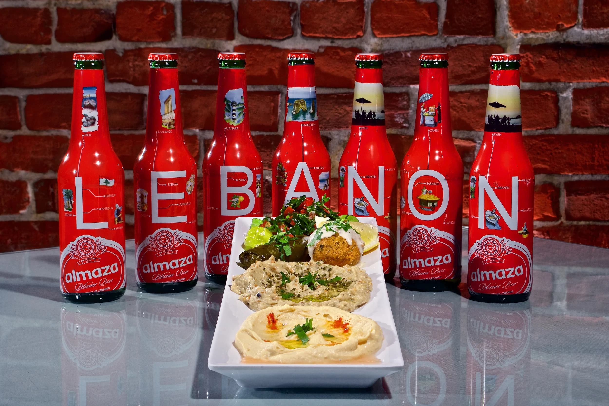 A mezze platter with falafel, hummus and baba ghannooj alongside Almaza, Lebanon's classic pilsener