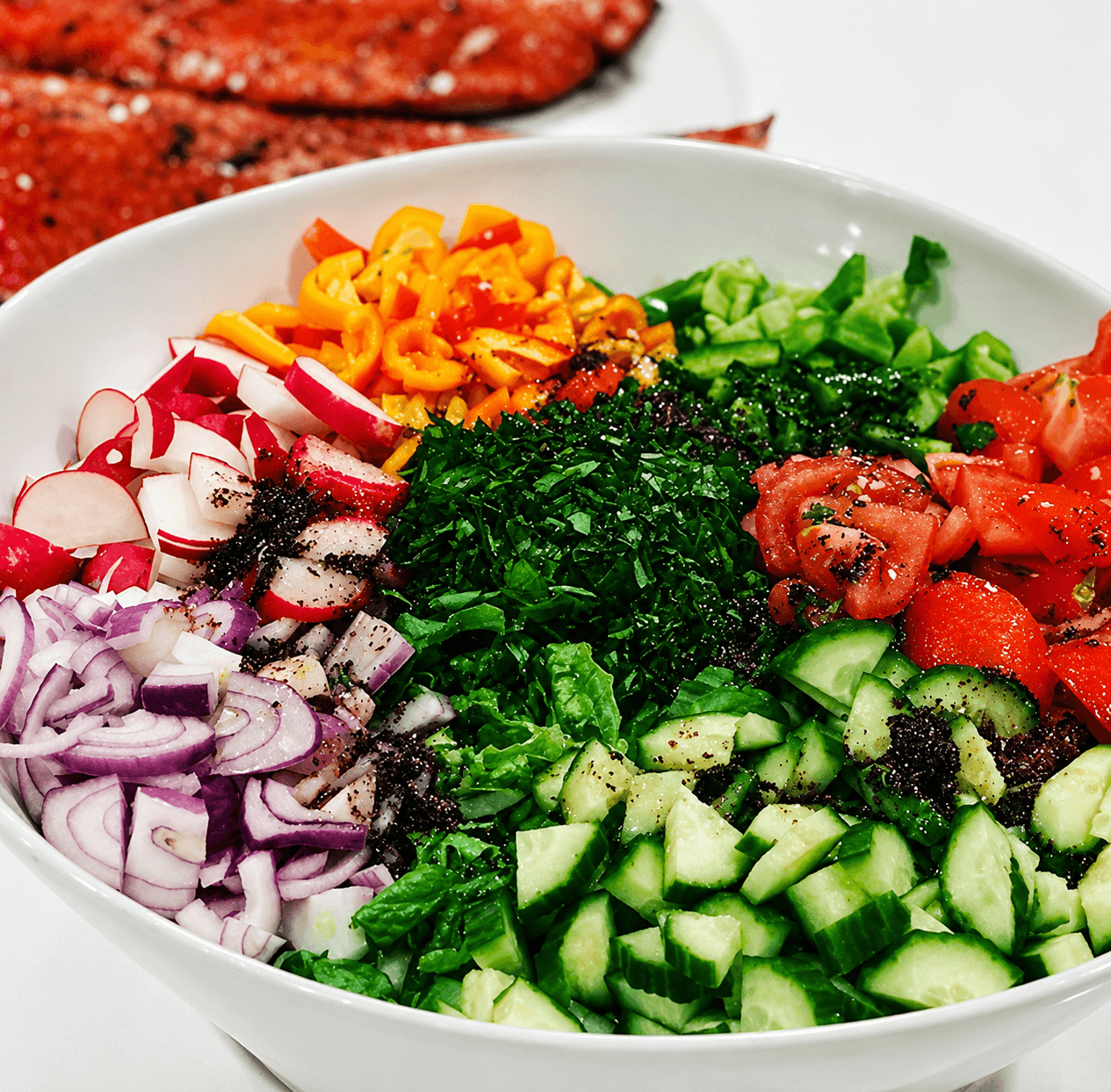 A fresh Lebanese salad of cucumbers, tomatoes, radish, peppers and herbs prepared by Al-Amir